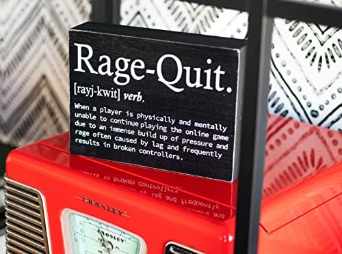 Decorative Sign with Rage-Quit Definition on a Shelf